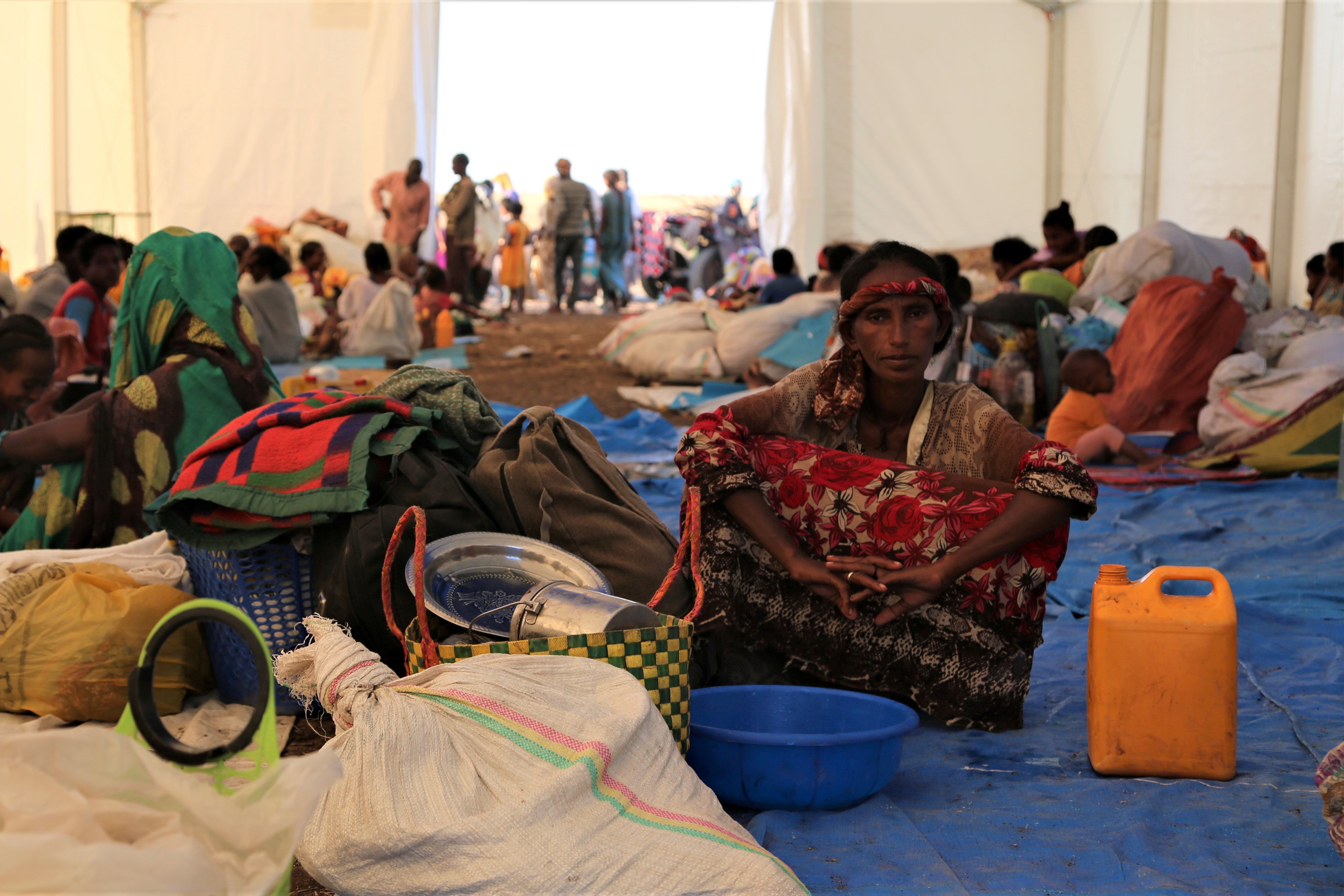 Ethiopians who fled the ongoing fighting in Tigray region, wait to be processed for emergency food and logistics support by the World Food Program in Hamdait village on the Sudan-Ethiopia border in eastern Kassala state, Sudan November 17, 2020.