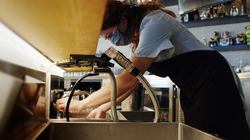 Woman  business owner working at a sink