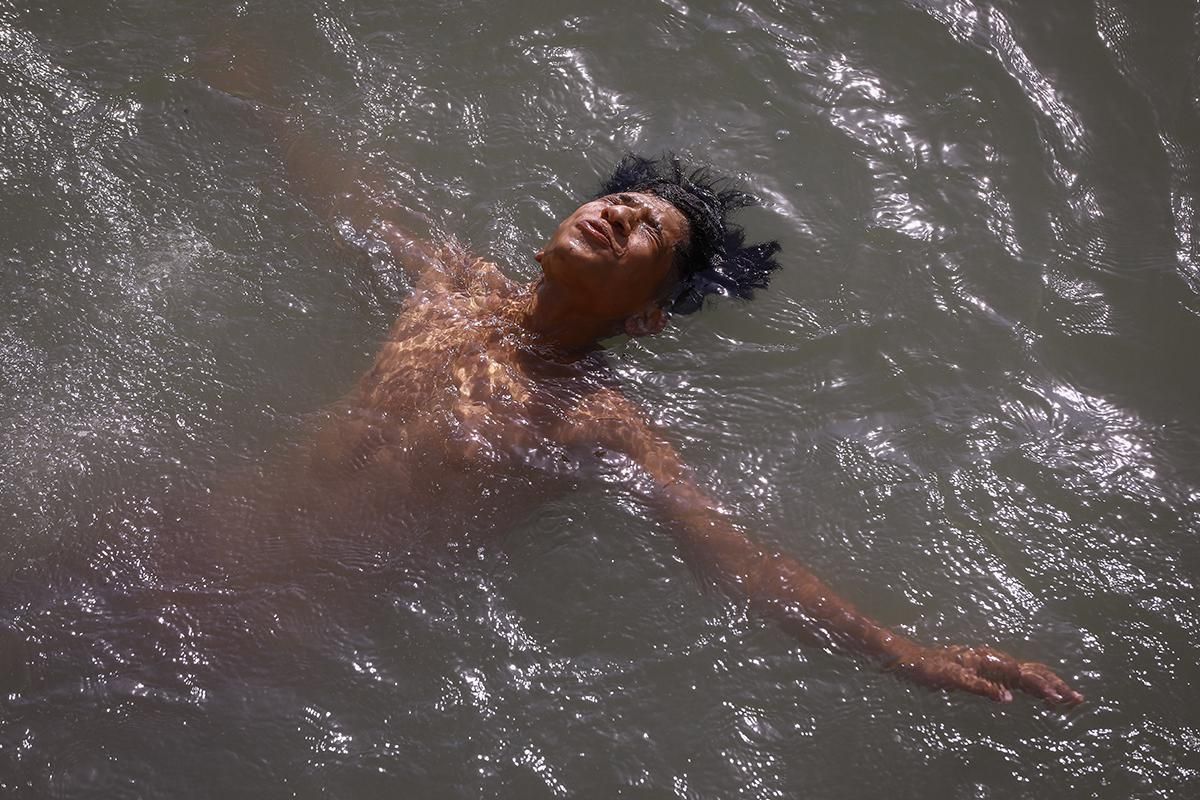 A boy swims in the Tigris River at Baghdad's Al-Adhamiyah neighbourhood to cool off amid an ongoing heatwave.