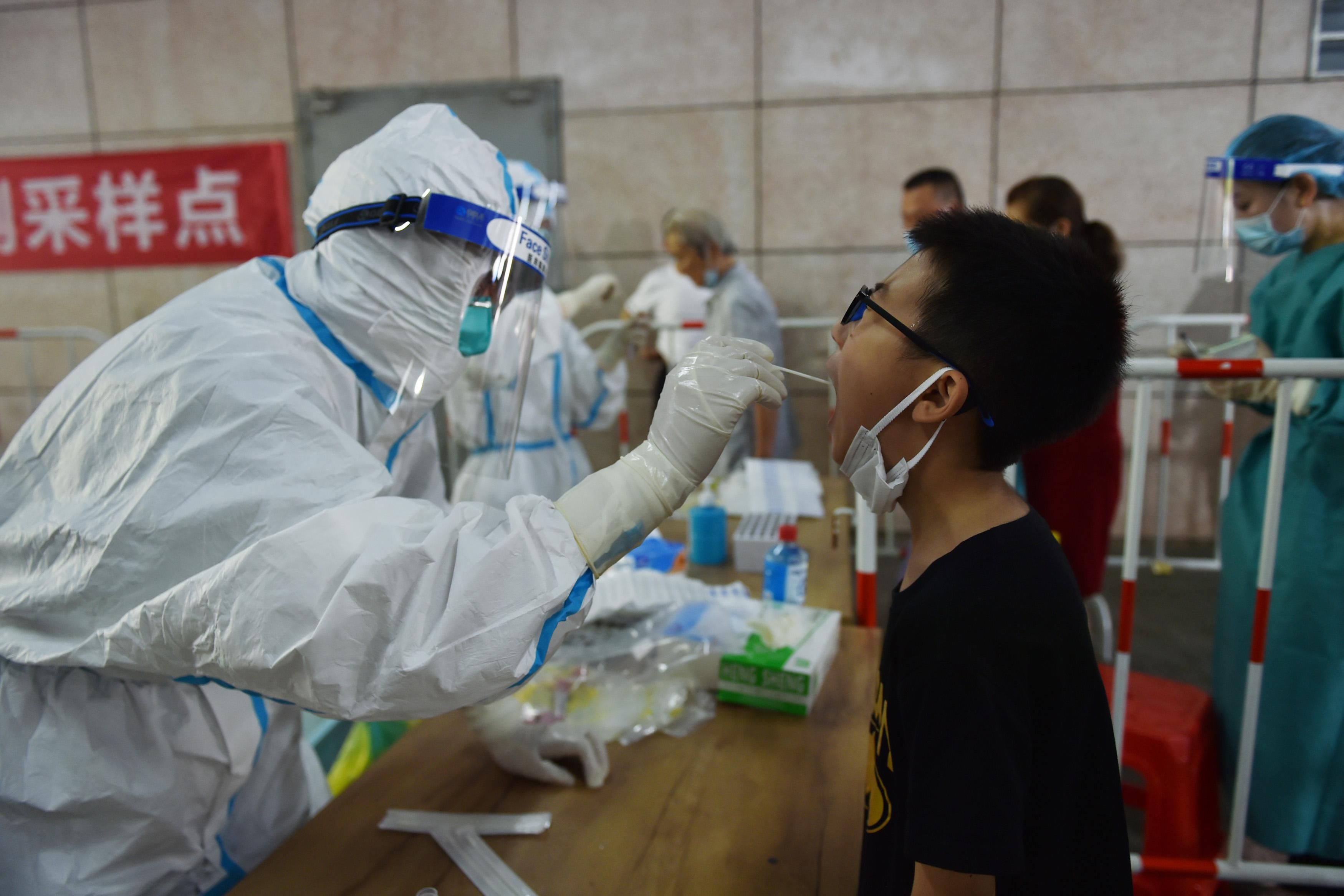 Citizens line up for COVID-19 nucleic acid test at a testing site in Yuhuatai District of Nanjing City, east China's Jiangsu Province, 2 August 2021. Nanjing City launches the fourth round of Covid-19 test.