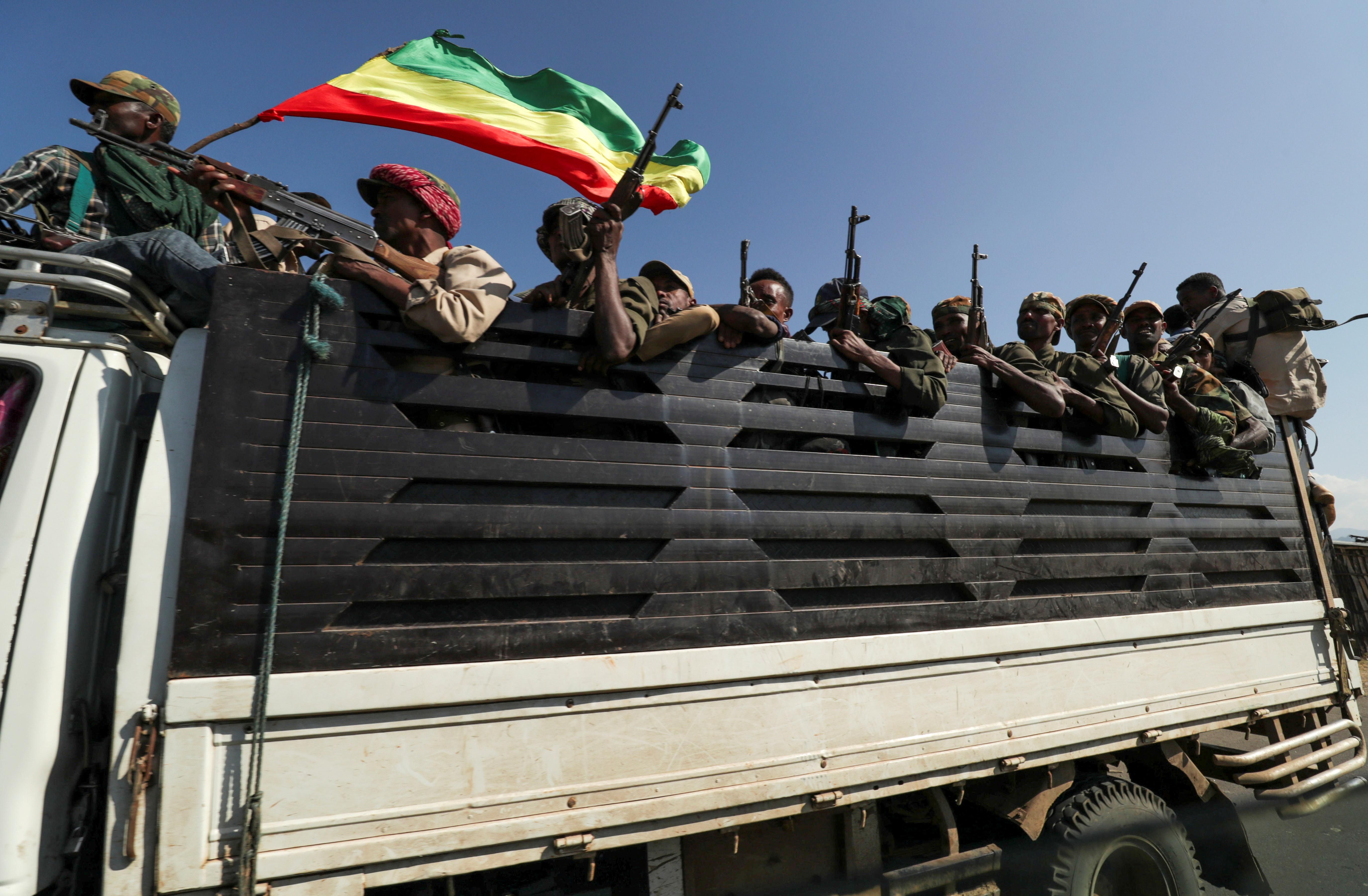 Members of Amhara region militias ride on their truck as they head to face the Tigray People's Liberation Front (TPLF), in Sanja, Amhara region near a border with Tigray, Ethiopia November 9, 2020