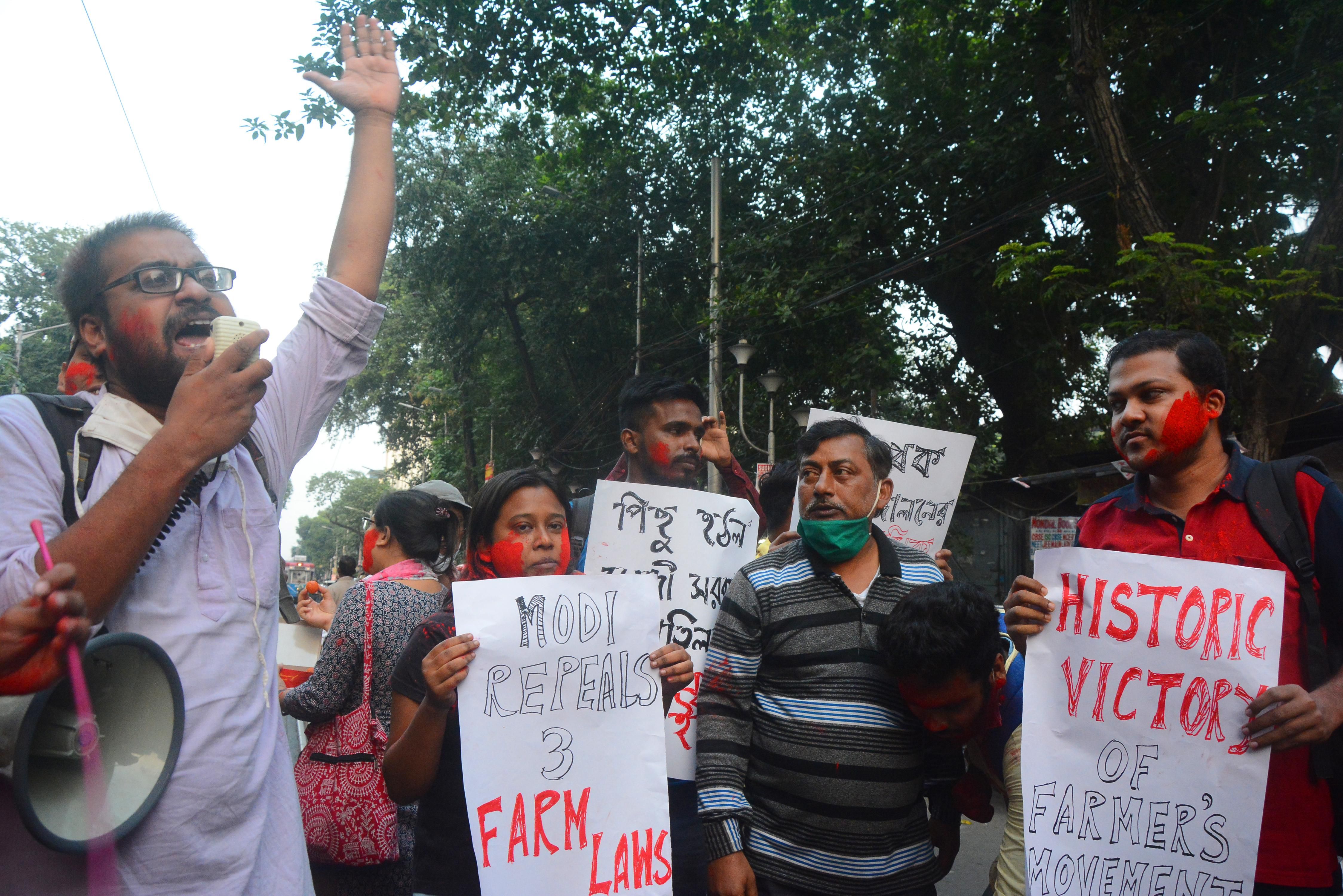 People celebrate in Kolkata, India on Nov. 19, 2021 after Indian PM Narendra Modi announced the repeal of three controversial farm laws after a year of protests. Friday's surprise announcement marks a major U-turn as the government had not taken any initiative to talk to farmers in recent months. 