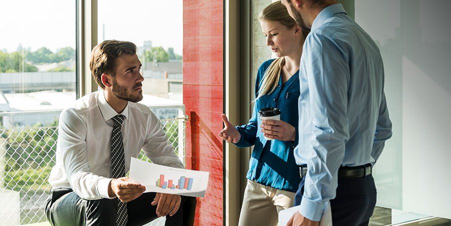 Three colleagues discussing their business in the office