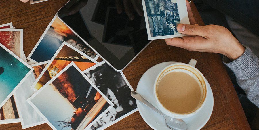 Coffee cup with photographs on a table