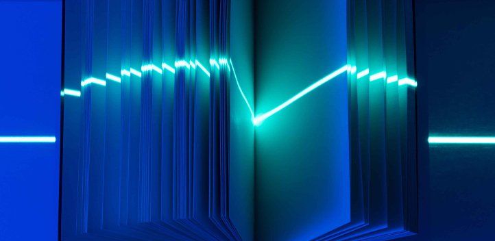 Open book with a laser pointed in the middle