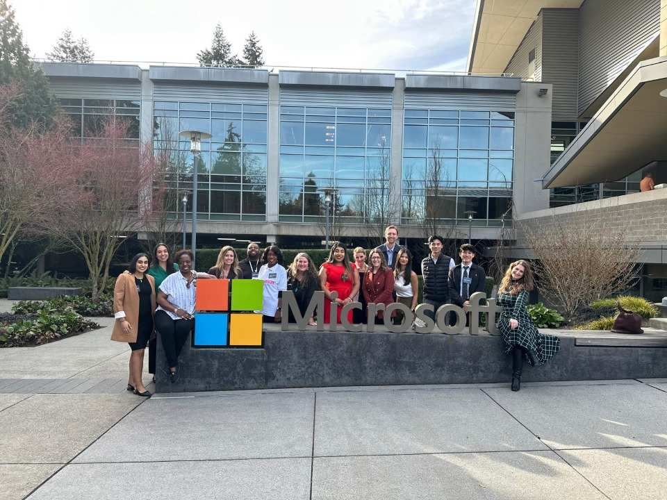 Employees in front of a Microsoft office