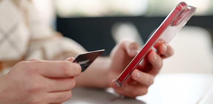 Person entering credit card details on an iPhone