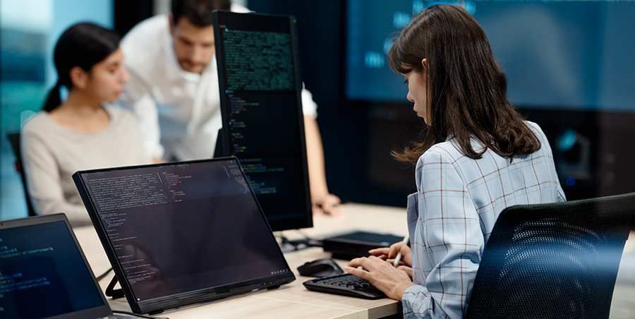 Woman on her desk typing on the keyboard at her work
