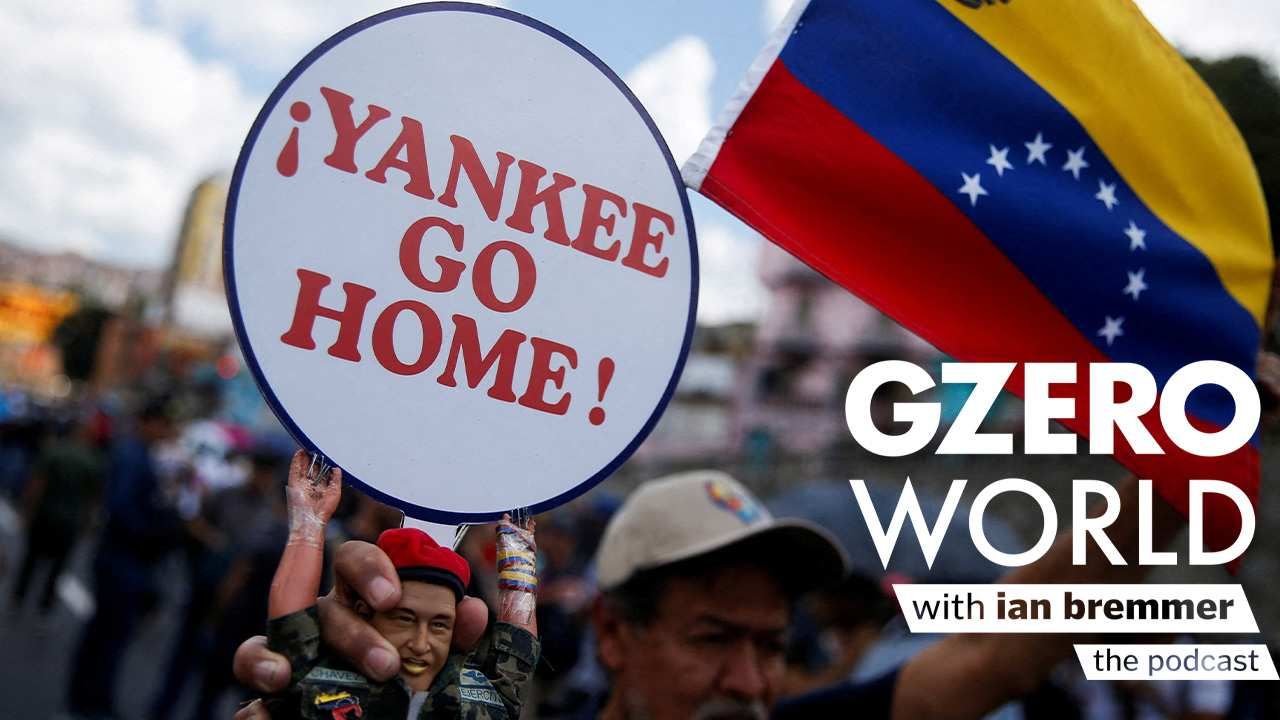 A Chavista holds a sign saying Yankee Go Home