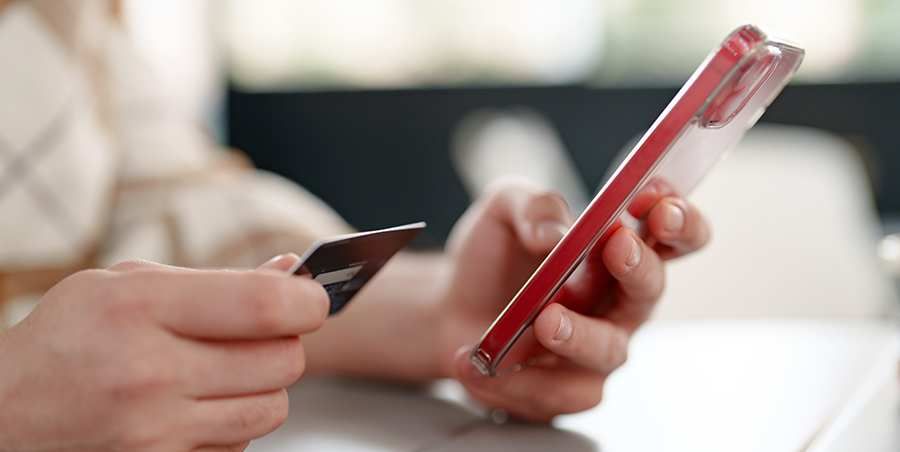 Person entering credit card details on a phone