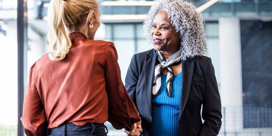 Two women shaking hands