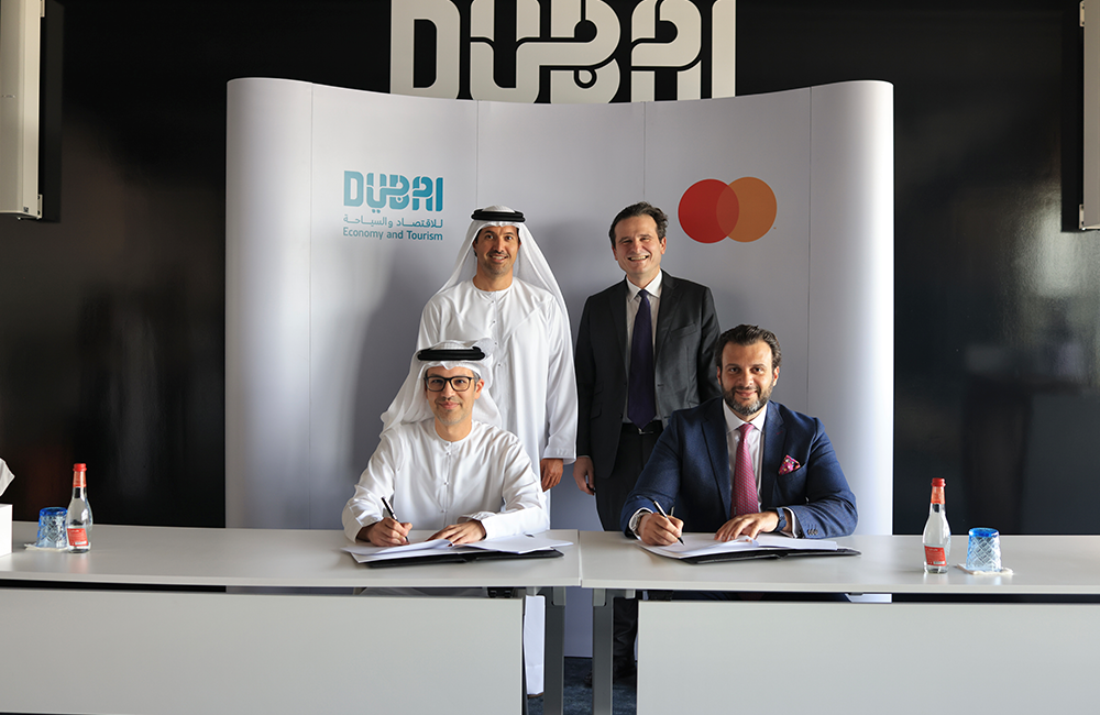 Four men signing a contract