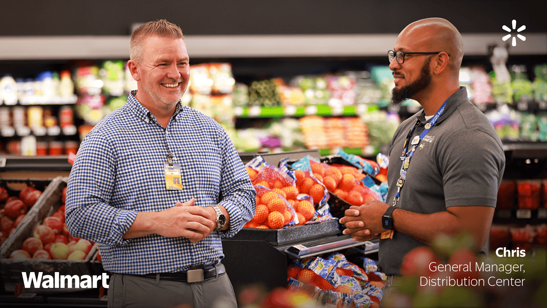 Two Walmart employees looking at each other and talking at a store