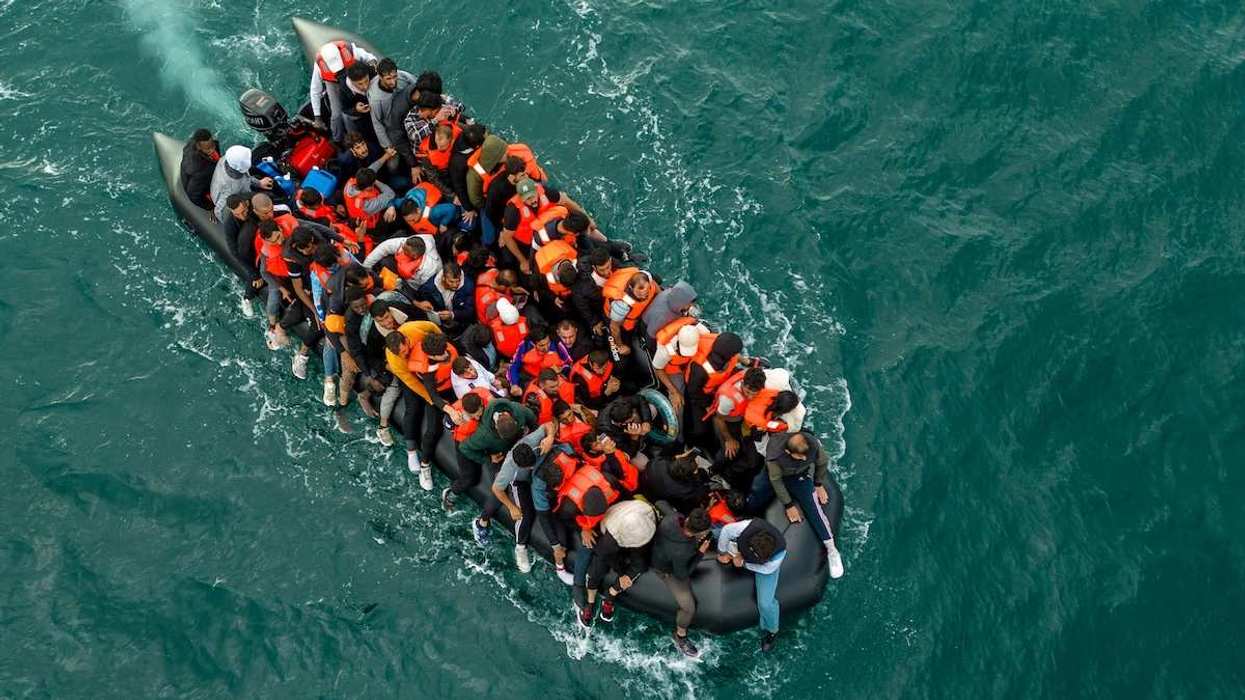 In this drone view an inflatable dinghy carrying migrants makes its way towards England in the English Channel, Britain.