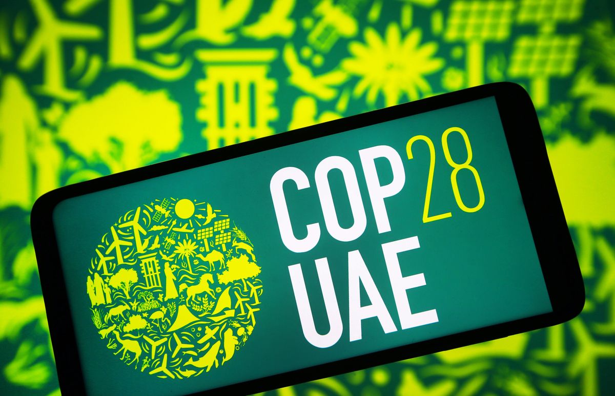 ​In this photo illustration, the 2023 United Nations Climate Change Conference COP28 UAE logo is seen on a smartphone screen. 