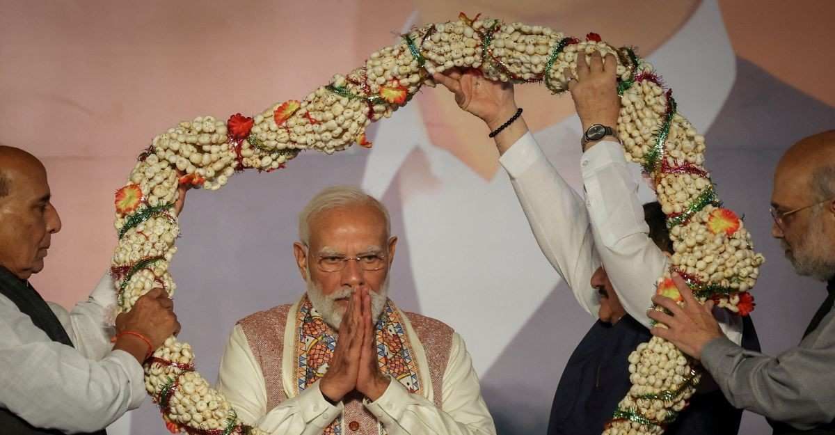 ​India's Home Minister Amit Shah and India's Defence Minister Rajnath Singh present a garland to Prime Minister Narendra Modi, as Bharatiya Janata Party (BJP) supporters celebrate the Bihar state assembly election results, at the party headquarters in New Delhi, India, November 14, 2025. 
