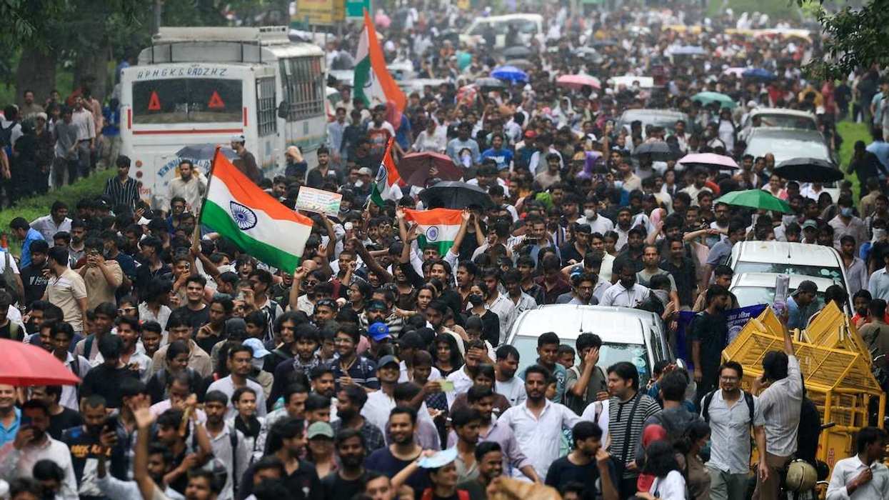 Indians storming the streets of New Delhi demanding the resignation of Education Minister Dharmendra Pradhan