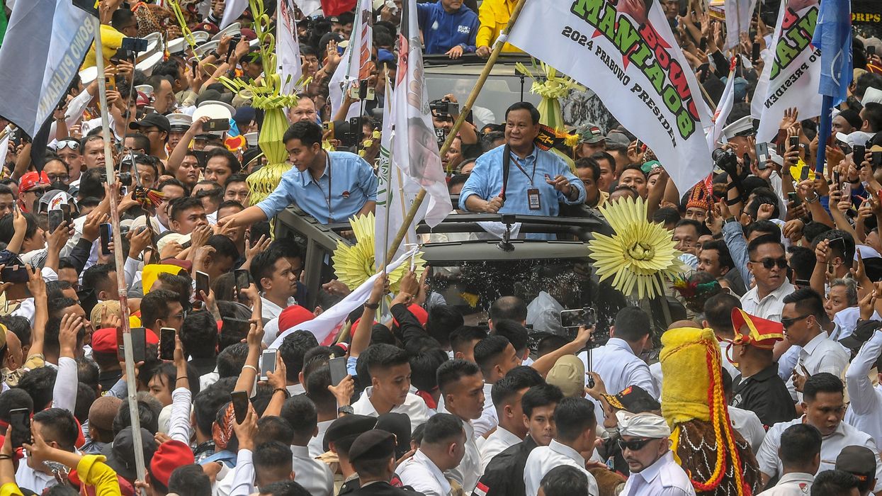 Indonesia's defence minister and presidential candidate, Prabowo Subianto, along with his running mate, Gibran Rakabuming Raka, who is the eldest son of Indonesian President Joko Widodo and Surakarta's Mayor, greet their supporters as they arrive at the election commission headquarters for registering themselves for next year's presidential election, in Jakarta, Indonesia, October 25, 2023