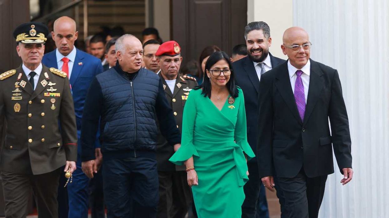 Interim President Delcy Rodriguez, in green, walks out of the National Assembly in Caracas, Venezuela, on January 5, 2026.