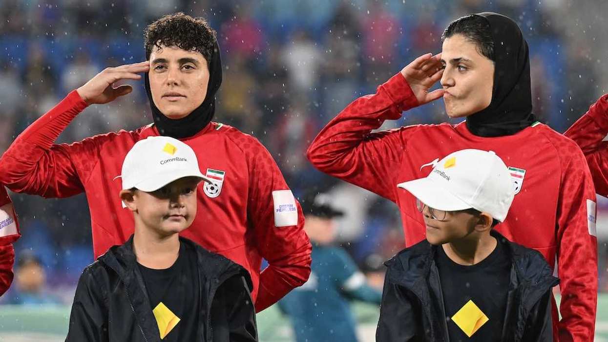 Iran player Fatemeh Pasandideh (right) reacts during the national anthem of Iran prior to the AFC Women’s Asian Cup Group A match between Iran and Philippines at Gold Coast Stadium on the Gold Coast, Sunday, March 8, 2026.
