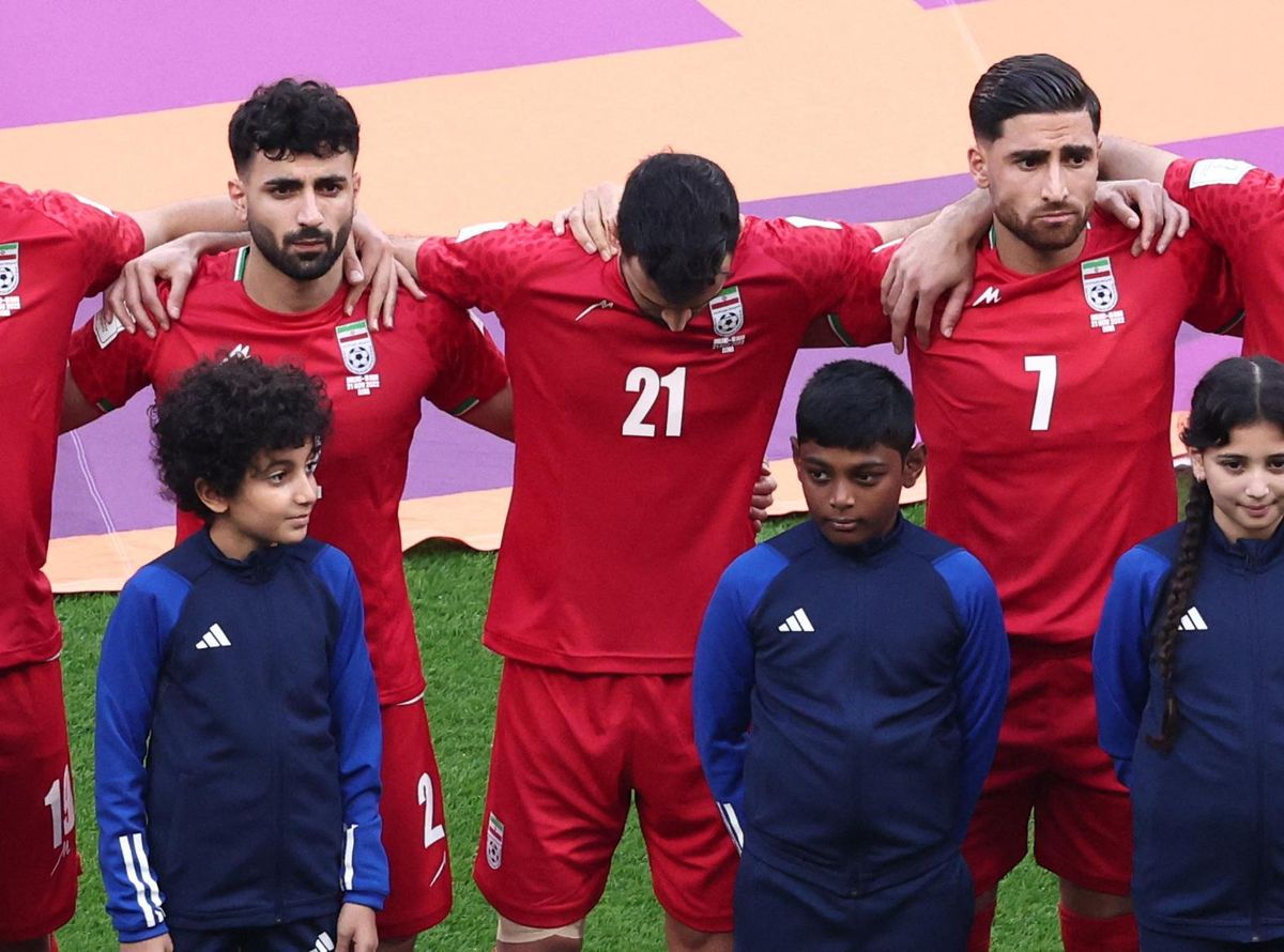Iran's Ahmad Noorollahi, Sadegh Moharrami, and Alireza Jahanbakhsh line up during the national anthems before the World Cup match against England.