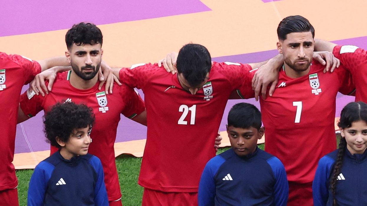 Iran's Ahmad Noorollahi, Sadegh Moharrami, and Alireza Jahanbakhsh line up during the national anthems before the World Cup match against England.