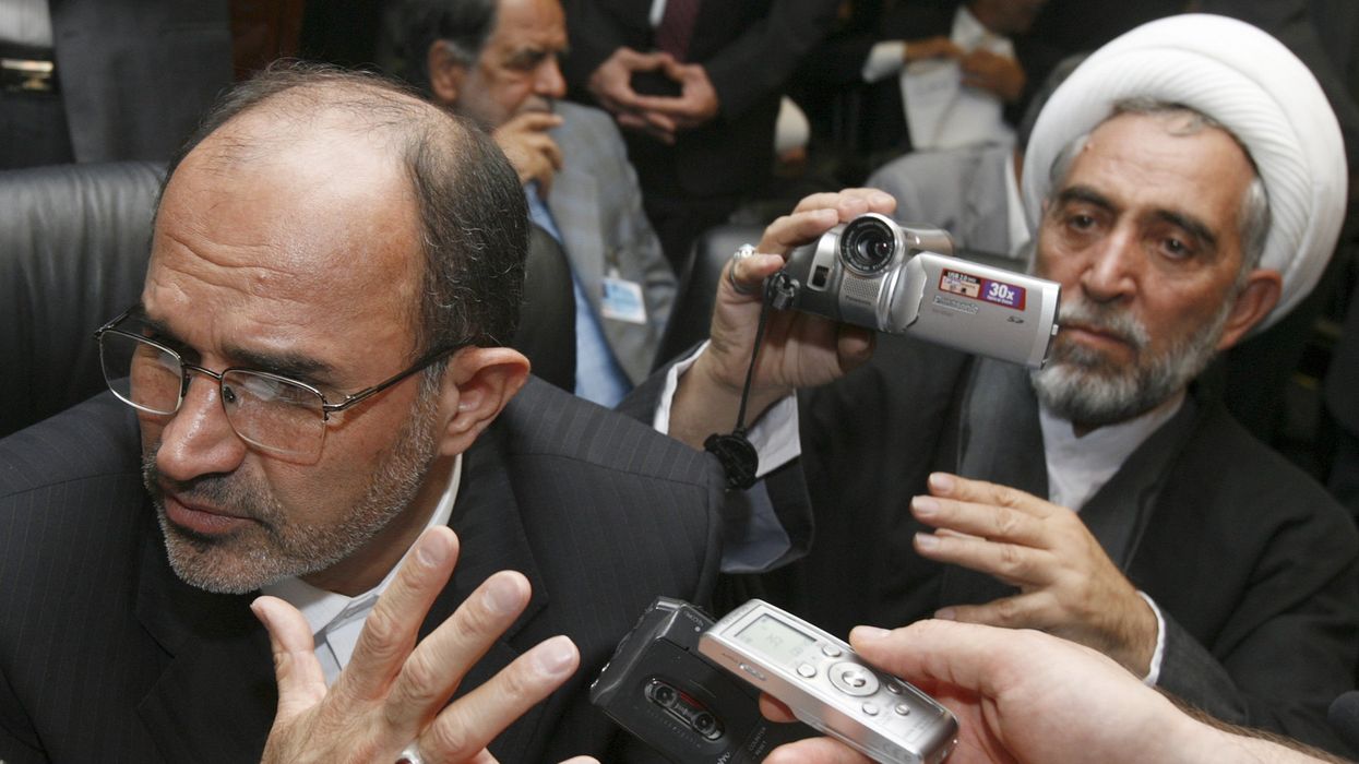Iranian oil minister Gholamhossein Nozari talks to journalists