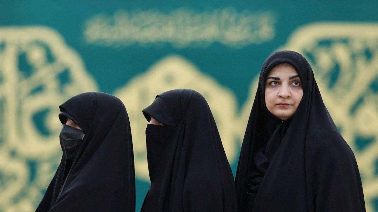 Iranian women queue to vote at a polling station in a snap presidential election to choose a successor to Ebrahim Raisi following his death in a helicopter crash, in Tehran, Iran June 28, 2024.