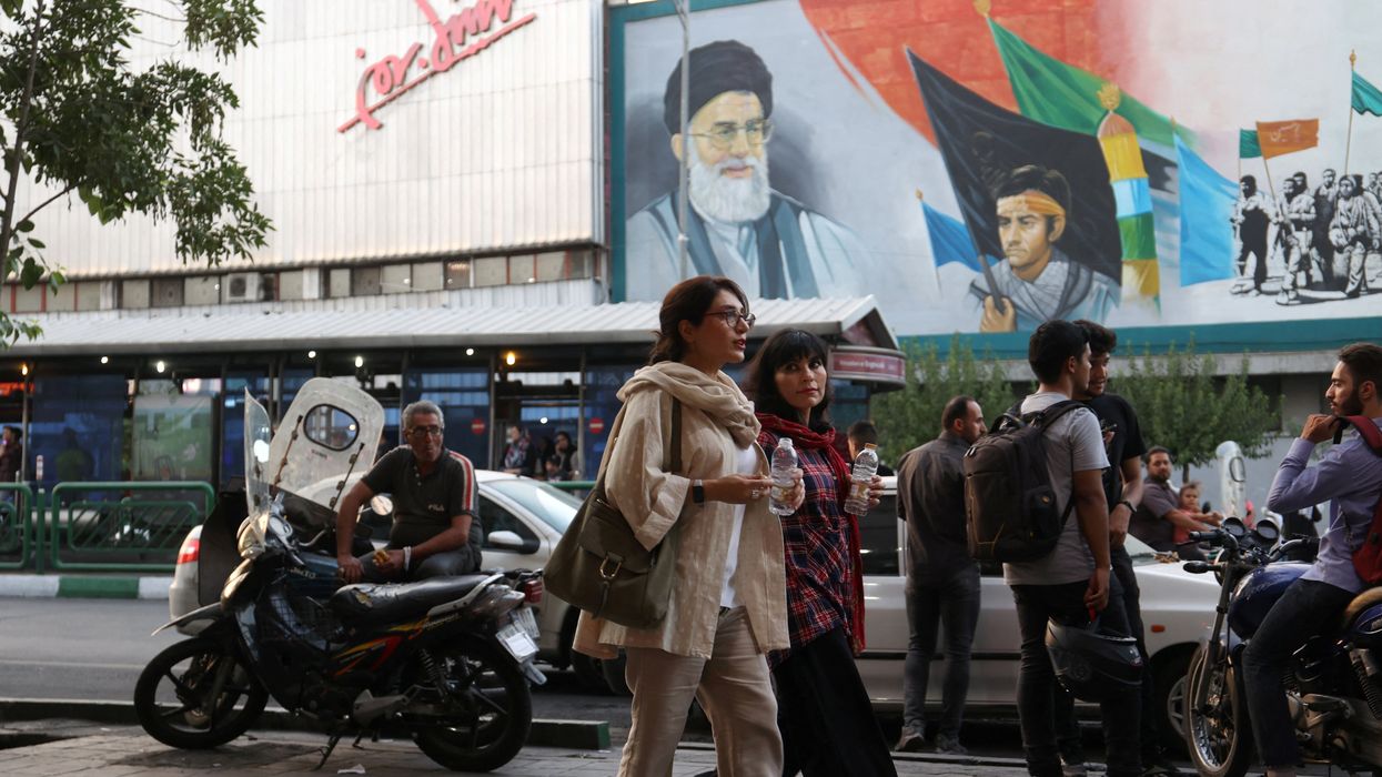 Iranian women walk down a street with their hair exposed despite the revival of the morality police in Tehran, Iran.