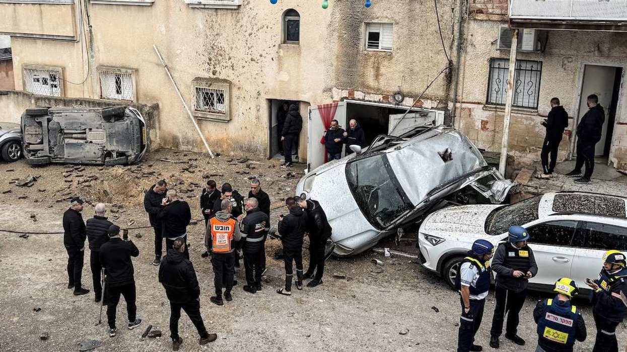 Israeli emergency services, security officials and residents gather at the missile impact site, after Iranian missile barrages were launched at Israel, amid the U.S.-Israel conflict with Iran, in the Arab city of Kafr Qassem in Israel, March 26, 2026. Picture taken using a mobile phone. 