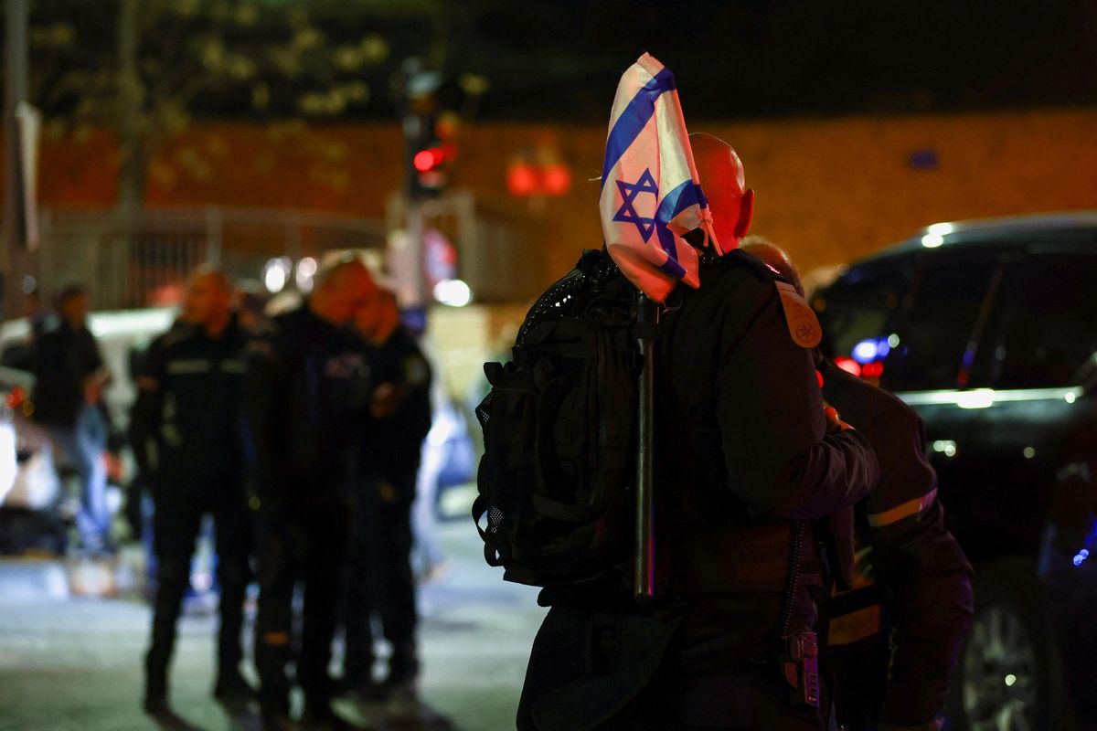 ​Israeli forces stand near the scene of a shooting attack in Neve Yaacov, Jerusalem