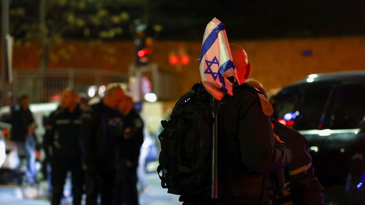 Israeli forces stand near the scene of a shooting attack in Neve Yaacov, Jerusalem