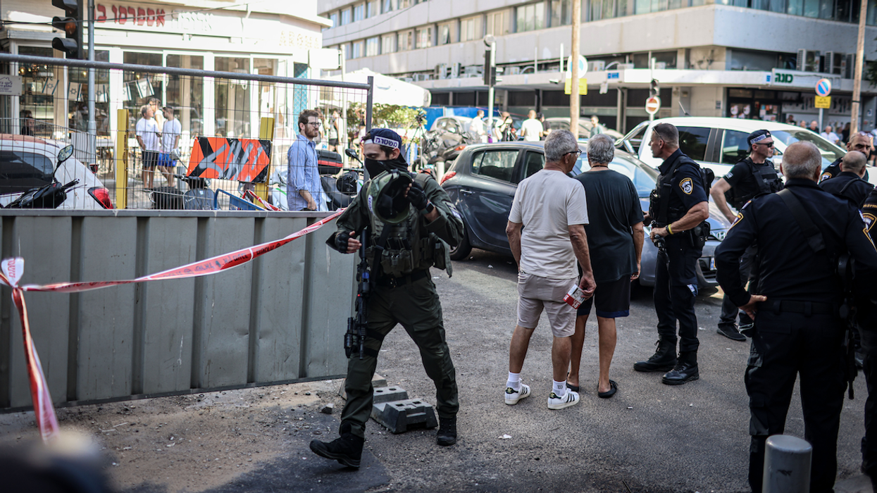 Israeli police search the scene of an explosion near a branch of the US embassy in Tel Aviv early Friday.