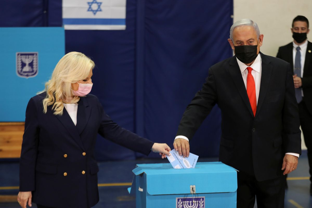 Israeli Prime Minister Benjamin Netanyahu and his wife Sara cast their ballots in Israel's general election, at a polling station in Jerusalem March 23, 2021
