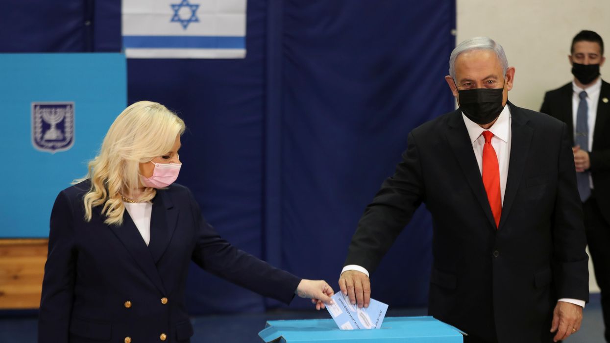 Israeli Prime Minister Benjamin Netanyahu and his wife Sara cast their ballots in Israel's general election, at a polling station in Jerusalem March 23, 2021