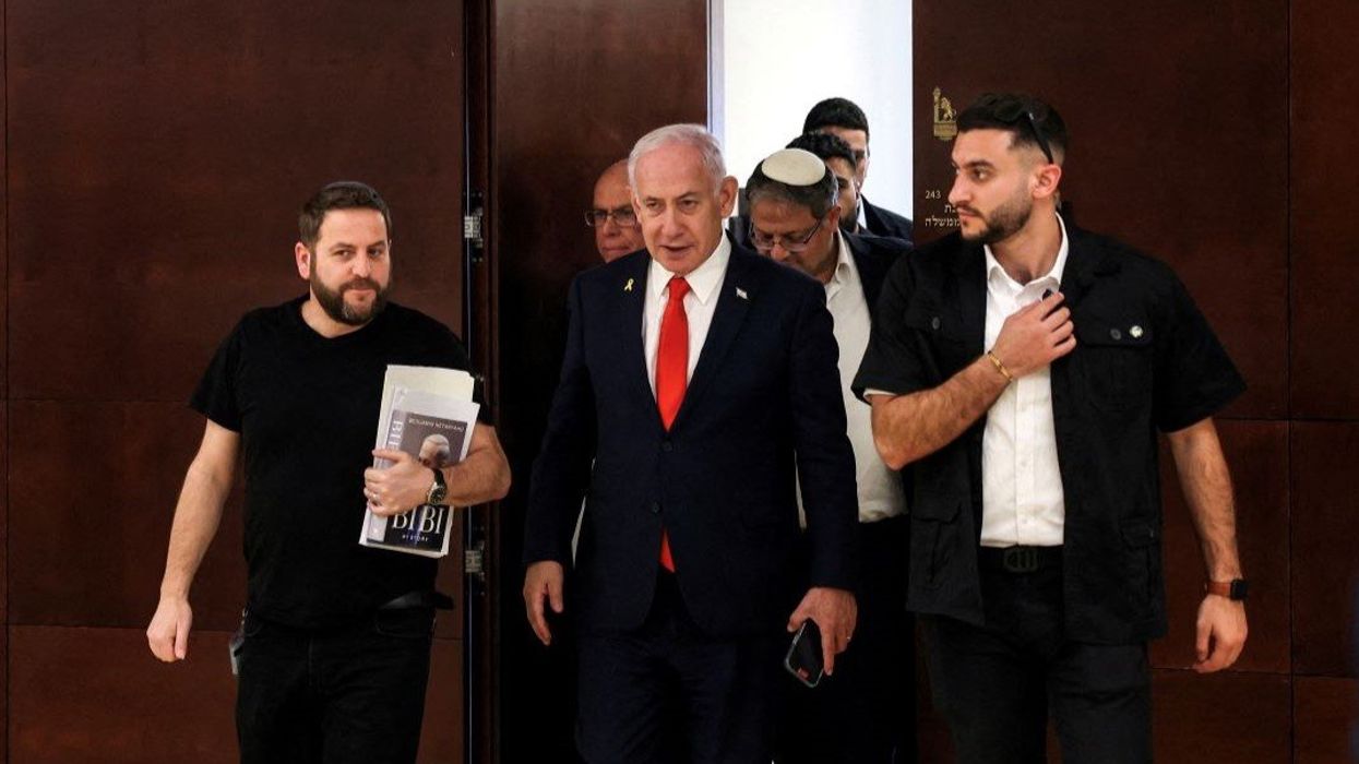 Israeli Prime Minister Benjamin Netanyahu followed by National Security Minister Itamar Ben-Gvir walk inside the Israeli parliament, the Knesset, in Jerusalem March 27, 2025.