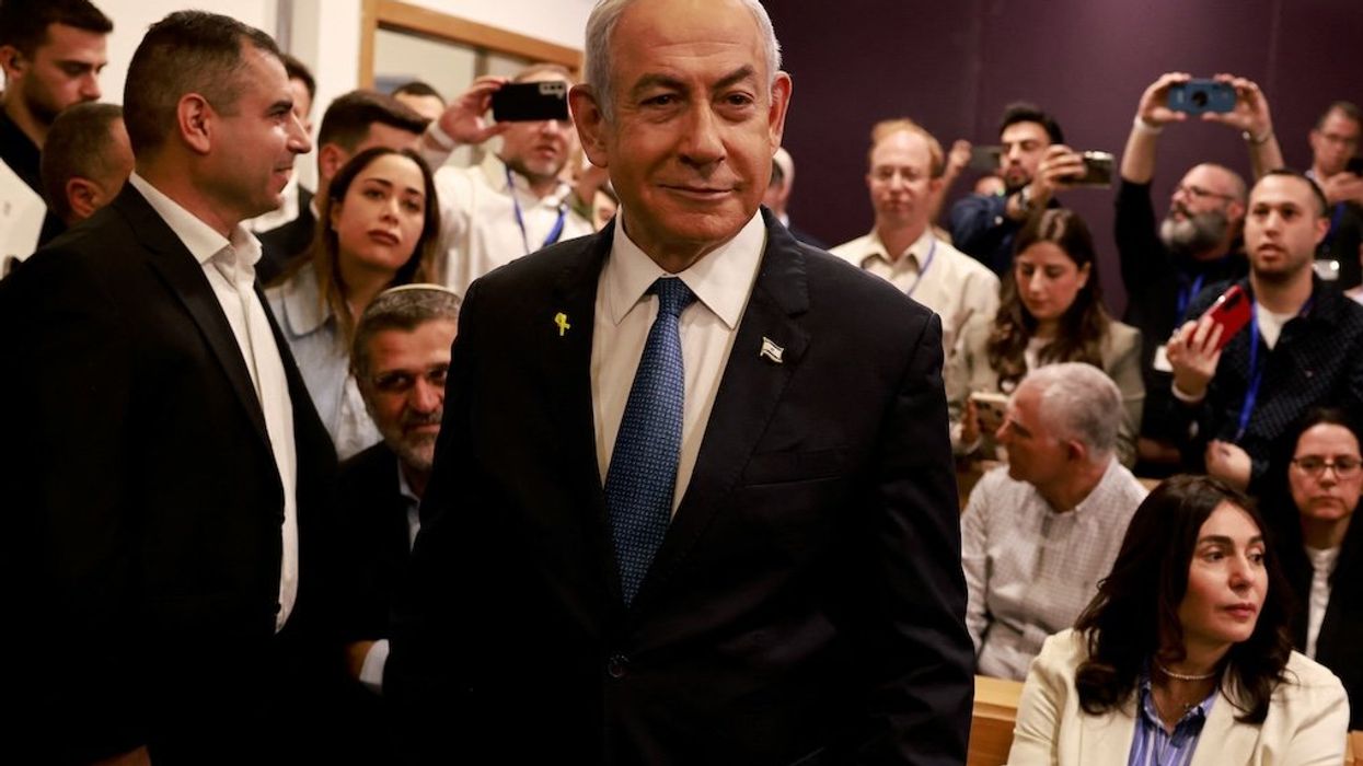 Israeli Prime Minister Benjamin Netanyahu smiles as he prepares to testify in his trial on corruption charges at the district court in Tel Aviv on Dec. 10, 2024.