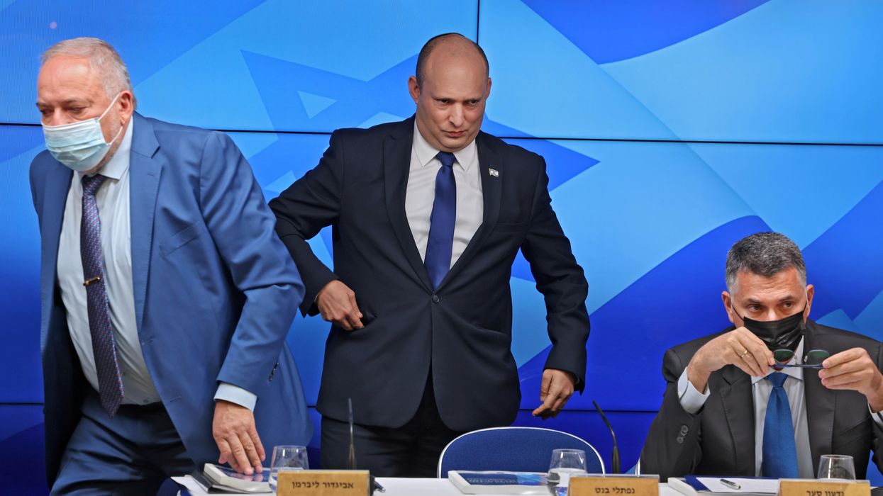 Israeli Prime Minister Naftali Bennett stands between Finance Minister Avigdor Lieberman and Justice Minister Gideon Saar at a news conference on economy in Jerusalem, July 6, 2021