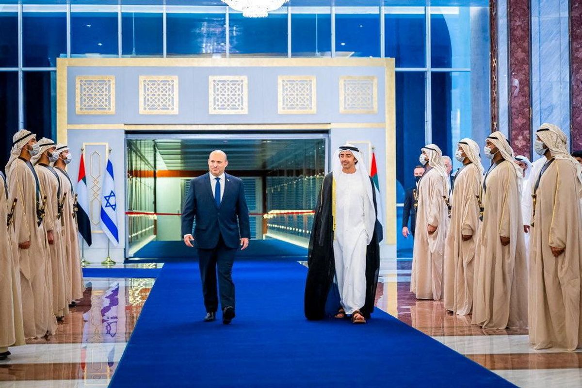 Israeli Prime Minister Naftali Bennett walks with United Arab Emirates Foreign Minister Sheikh Abdullah bin Zayed Al Nahyan during a welcoming ceremony upon his arrival in Abu Dhabi, United Arab Emirates December 12, 2021.
