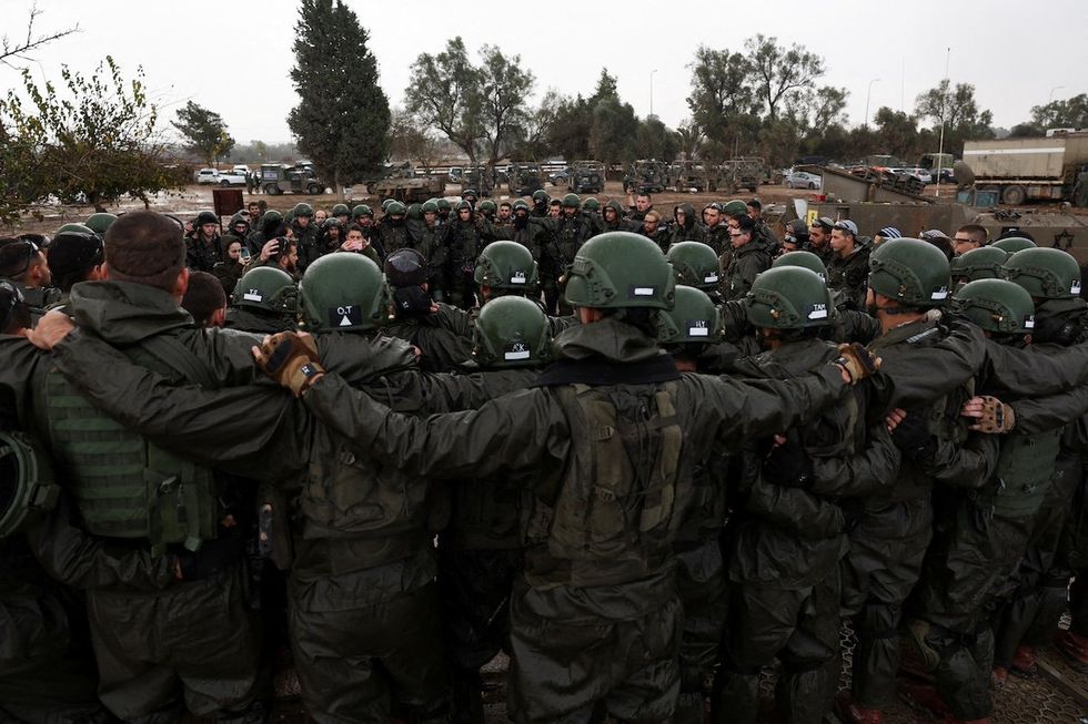 Israeli soldiers prepare to enter the Gaza Strip, amid the ongoing conflict between Israel and the Palestinian Islamist group Hamas, at Israel's border with Gaza in southern Israel, December 13, 2023.