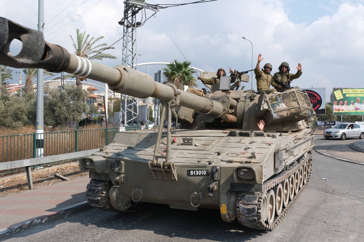 Israeli soldiers stand guard near the Israeli-Lebanon border in the northern town of Shlomi.