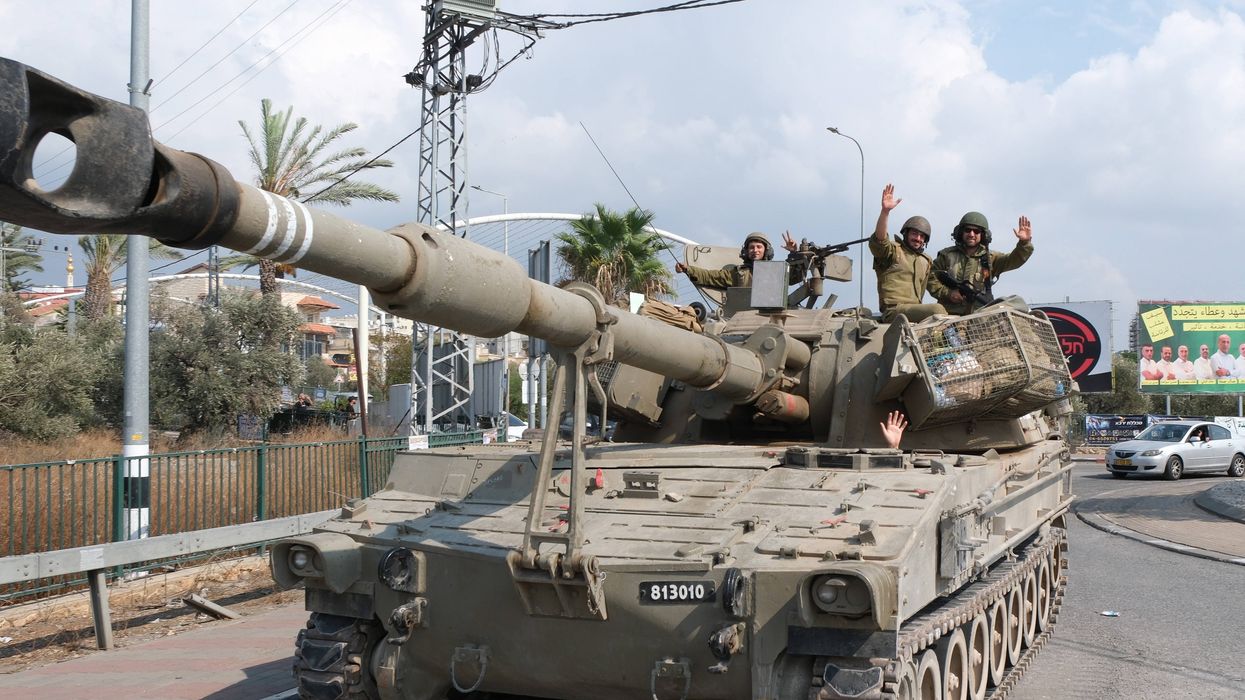 Israeli soldiers stand guard near the Israeli-Lebanon border in the northern town of Shlomi.