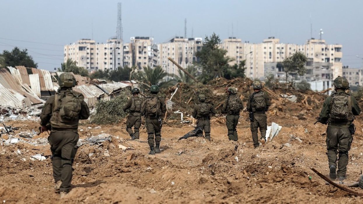 Israeli soldiers walk as they operate, amid the ongoing conflict between Israel and the Palestinian Islamist group Hamas, in Gaza, January 8, 2024.