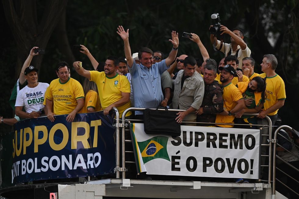 Jair Bolsonaro waves to supporters at September 7 rally. 