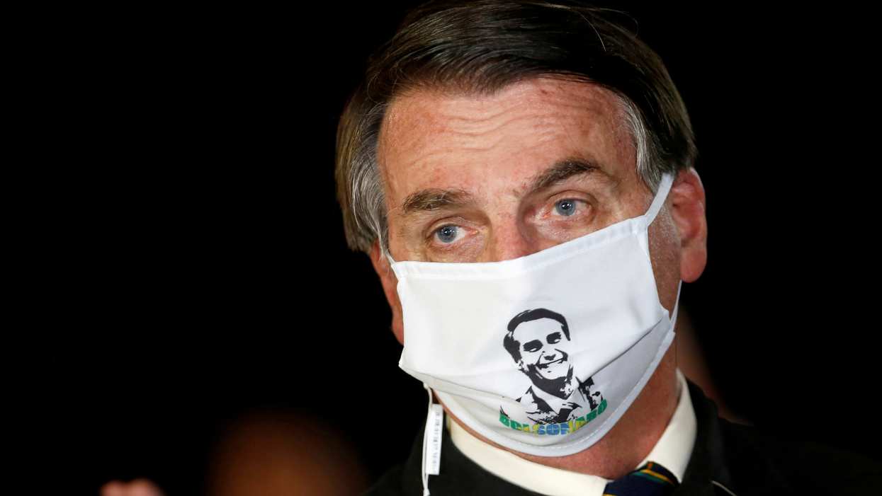 Jair Bolsonaro wears a mask with his image