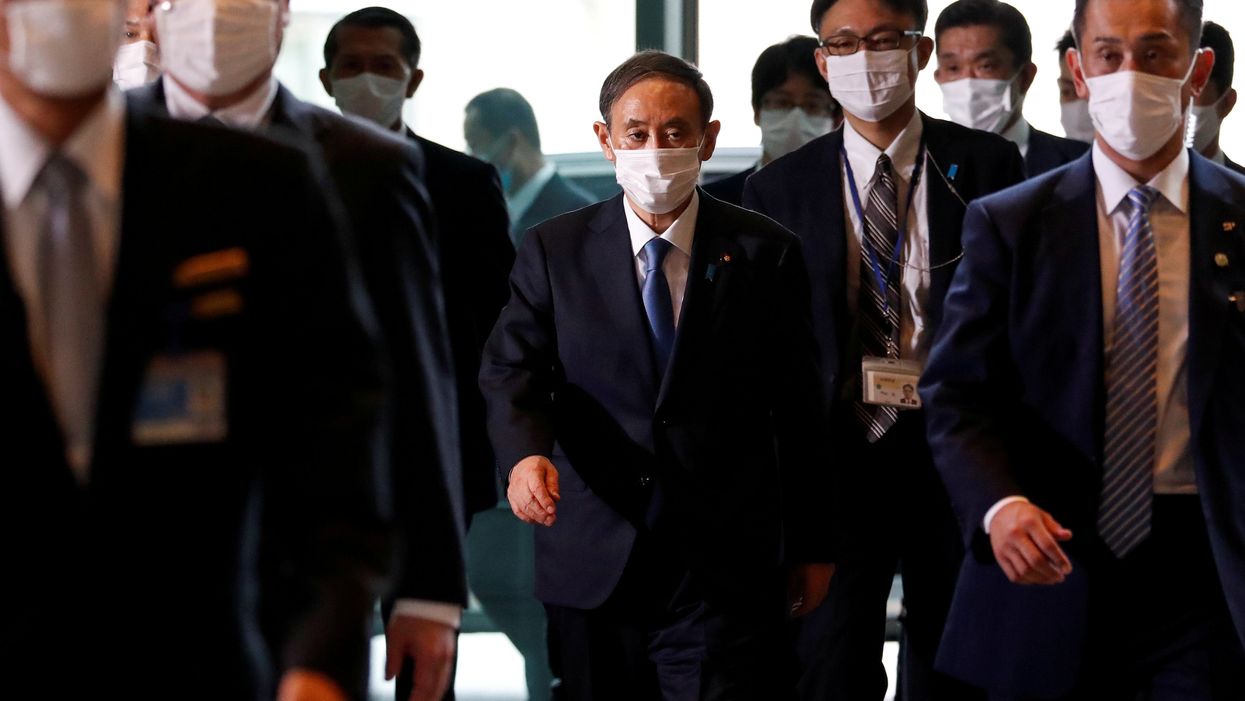 Japan's newly-elected Prime Minister Yoshihide Suga arrives at his official residence in Tokyo