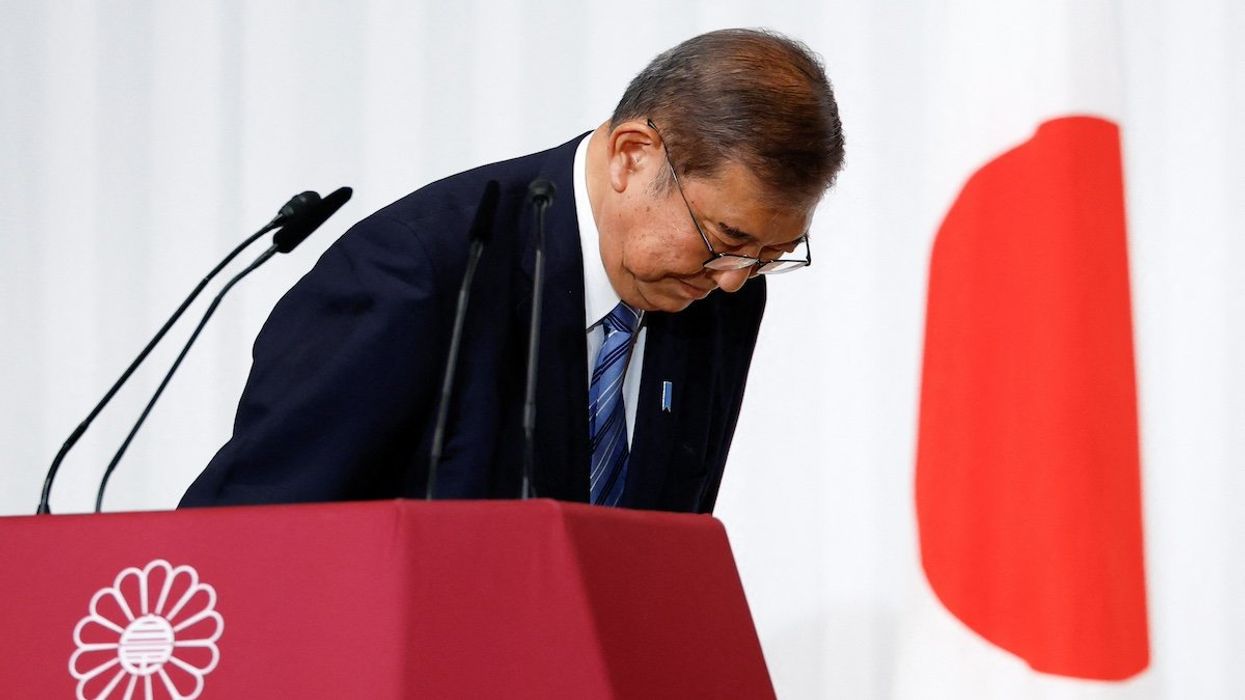 Japanese Prime Minister and leader of the ruling Liberal Democratic Party (LDP) Shigeru Ishiba bows to LDP lawmakers onstage after a press conference, a day after Japan's lower house election, at the party's headquarters in Tokyo, Japan October 28, 2024.