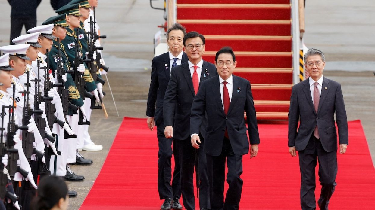 Japanese Prime Minister Fumio Kishida arrives to attend the trilateral summit with his South Korean and Chinese counterparts in Seoul, South Korea.