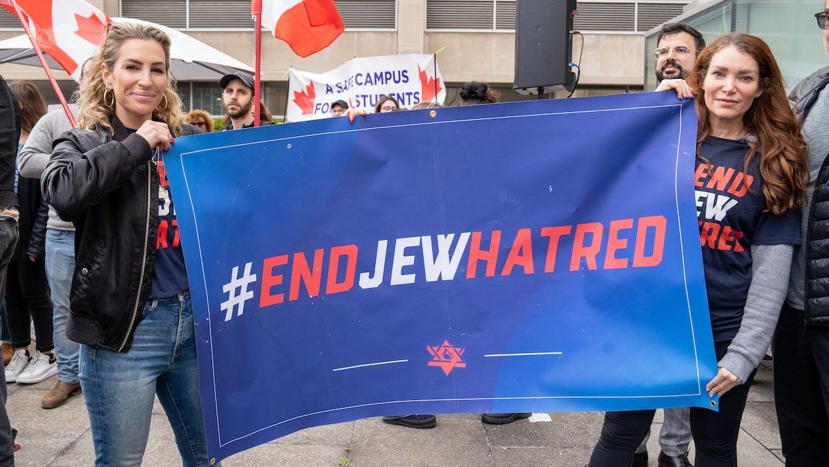 Jewish students, supporters and U of T faculty hold a banner during the rally against hate. 