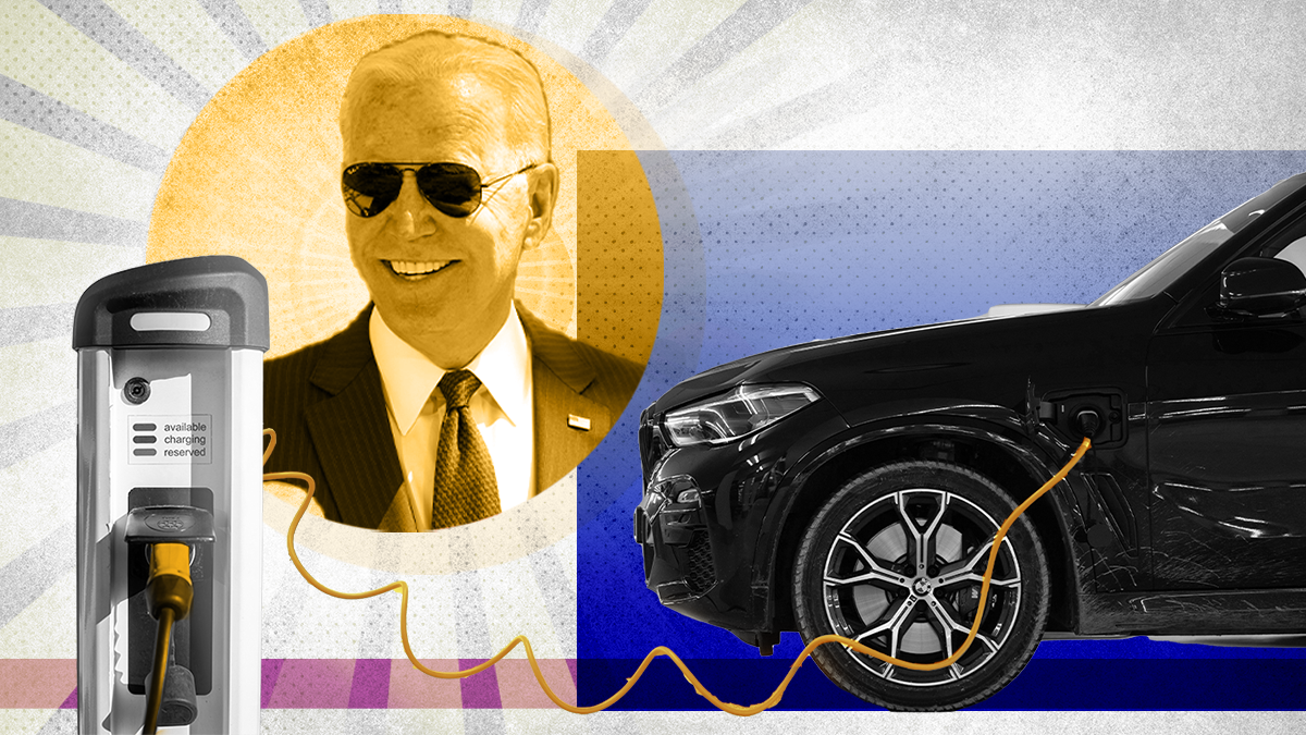 Joe Biden cutout smiling at an electric vehicle charging